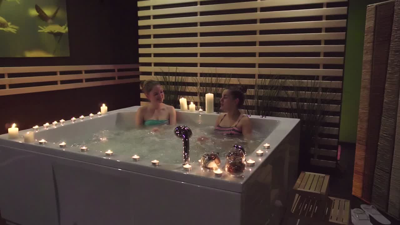 Two women relaxing in a spa hot tub
