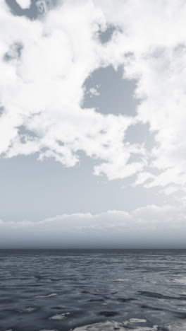 calm ocean with white clouds in the sky