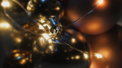 Beautiful-Golden-Christmas-Baubles-Hanged-And-Displayed-With-Lights---Close-Up-Shot