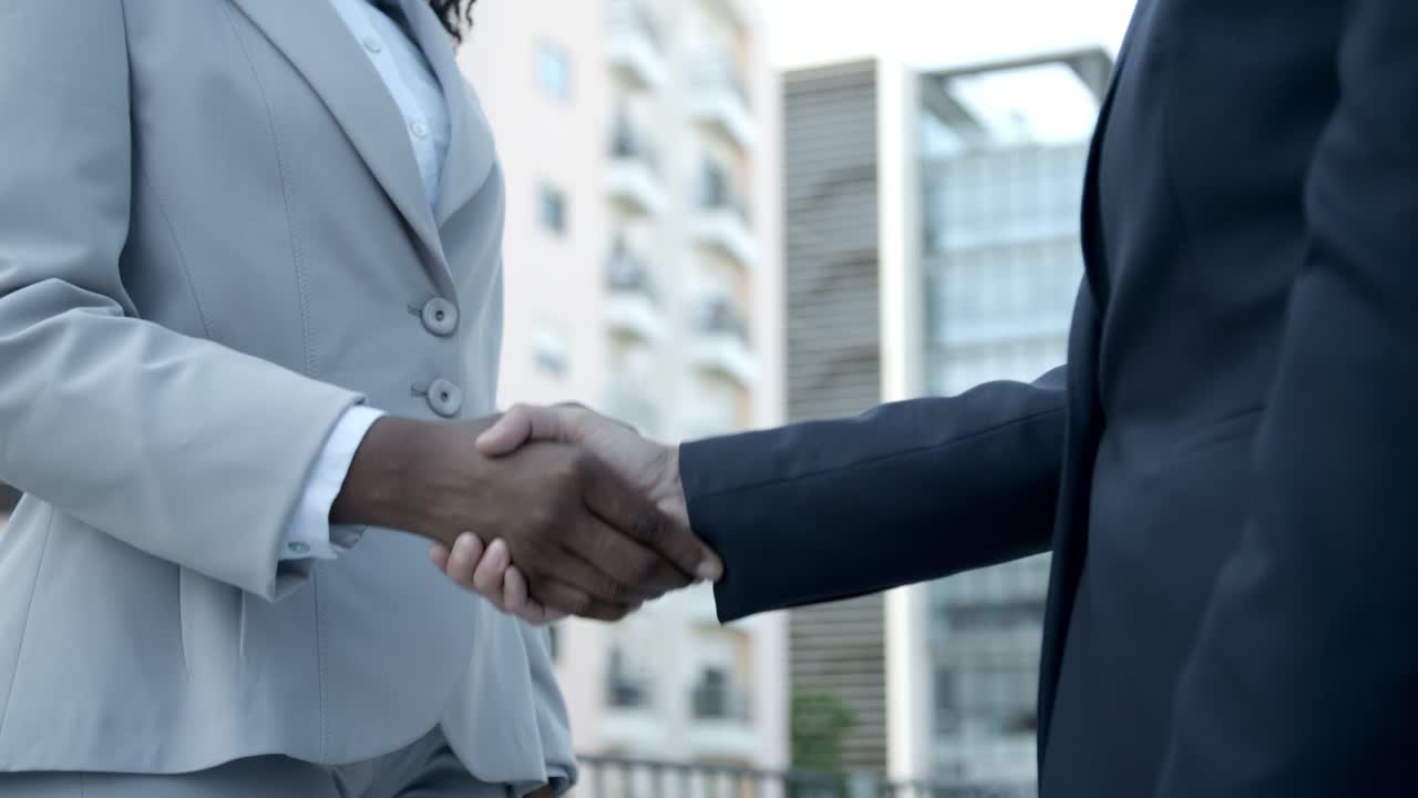 Slow motion shot of business partners shaking hands