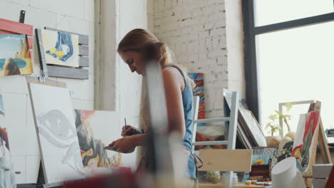 woman artist painting in a studio