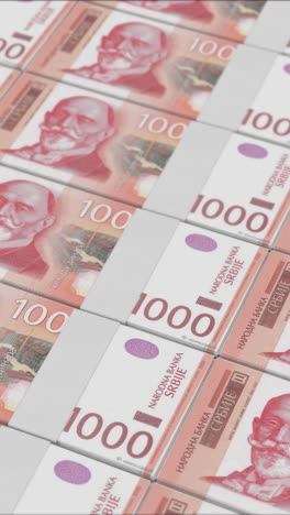vertical video of 1000 serbian dinar banknotes printed by a money press