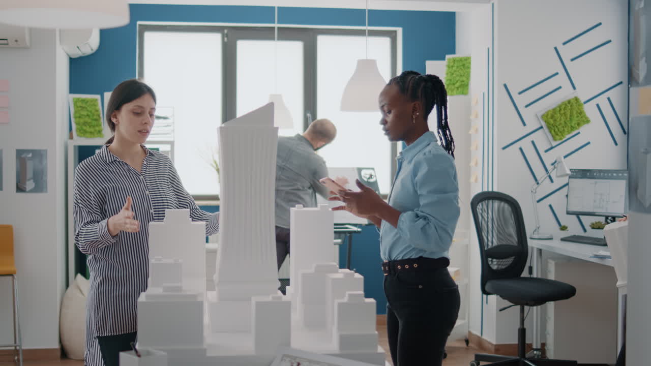 Architects collaborating on a building model in a design studio
