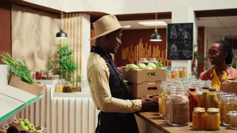 business owner restocking crates of fresh fruits and vegetables