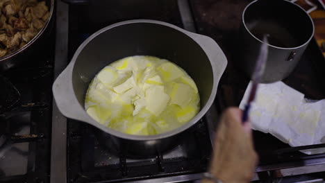 melting butter in a skillet, start of classic bagna cauda sauce