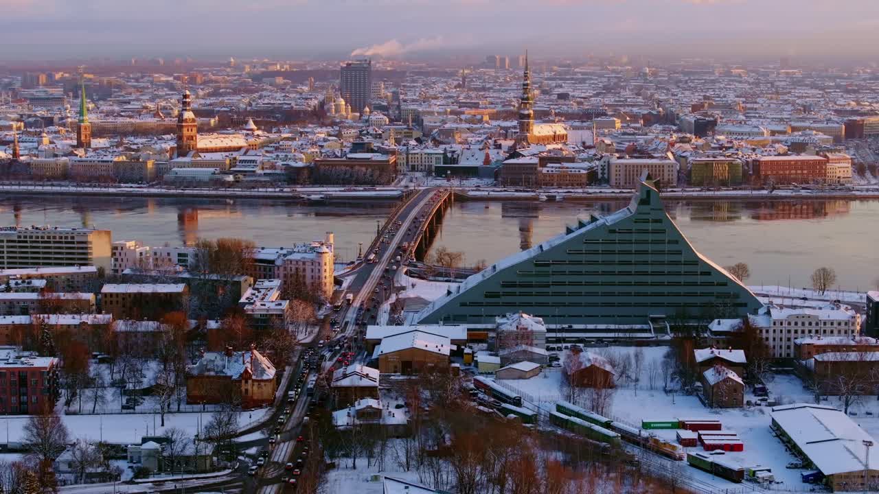 Golden sunrise of Riga cityscape, snowy Europe winter charm, drone, Latvia, 4K