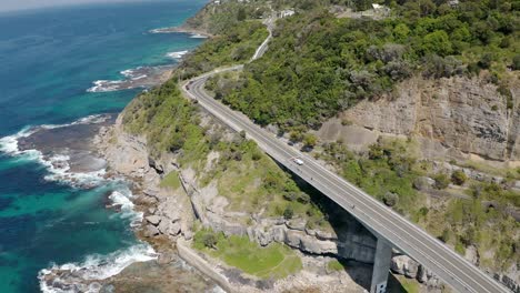 the 665 metres long sea cliff bridge is a highlight along the grand pacific drive at coalcliff nsw - aerial drone shot