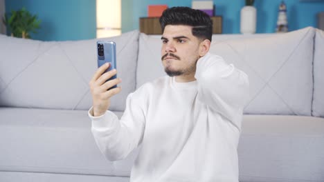 Young-man-looking-at-phone-confused.-Big-surprise.
