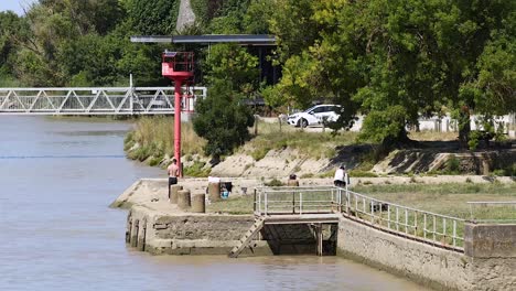 people walking and relaxing by the river