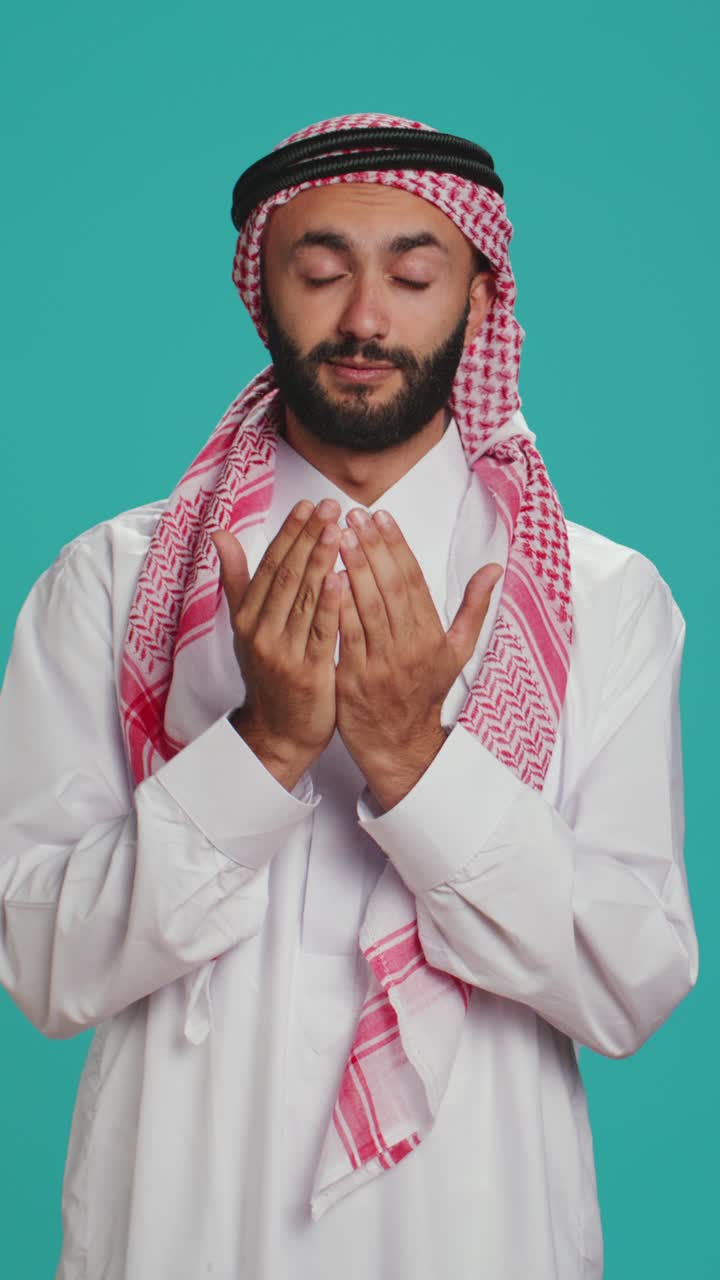 Video verticale di un uomo islamico che prega Allah in studio
