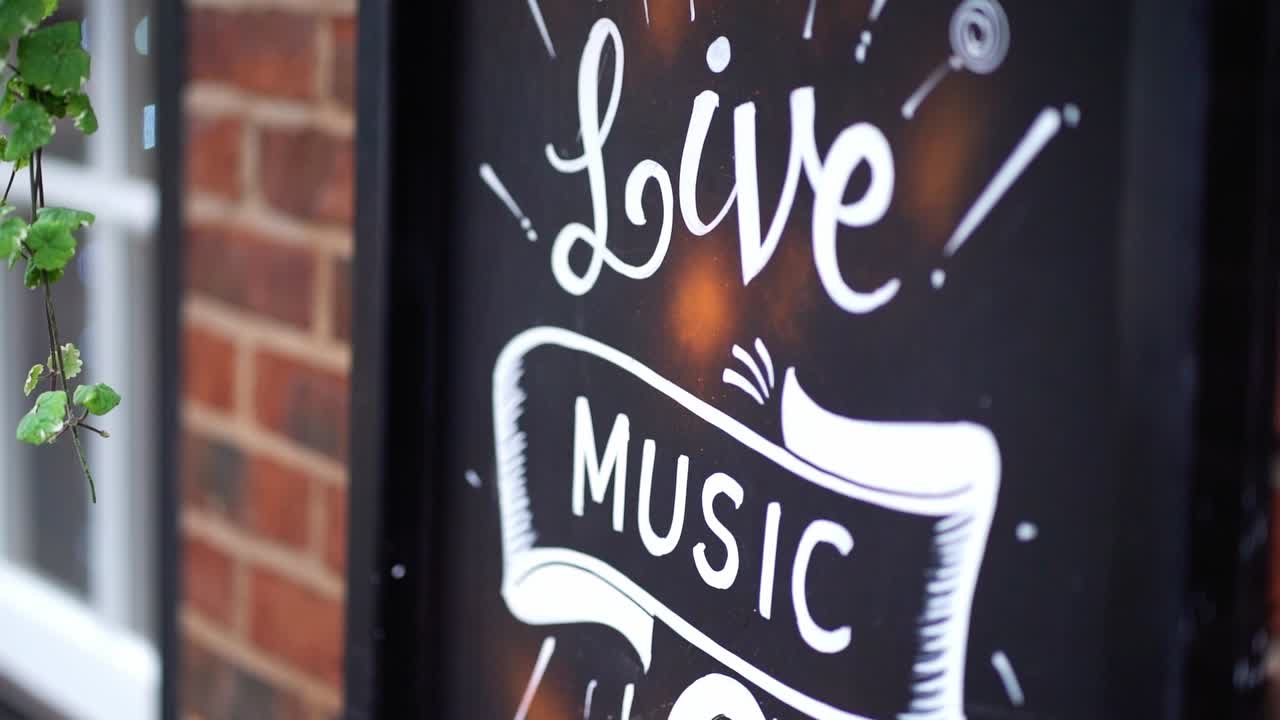 Un cartello fuori da un pub che promuove musica dal vivo.