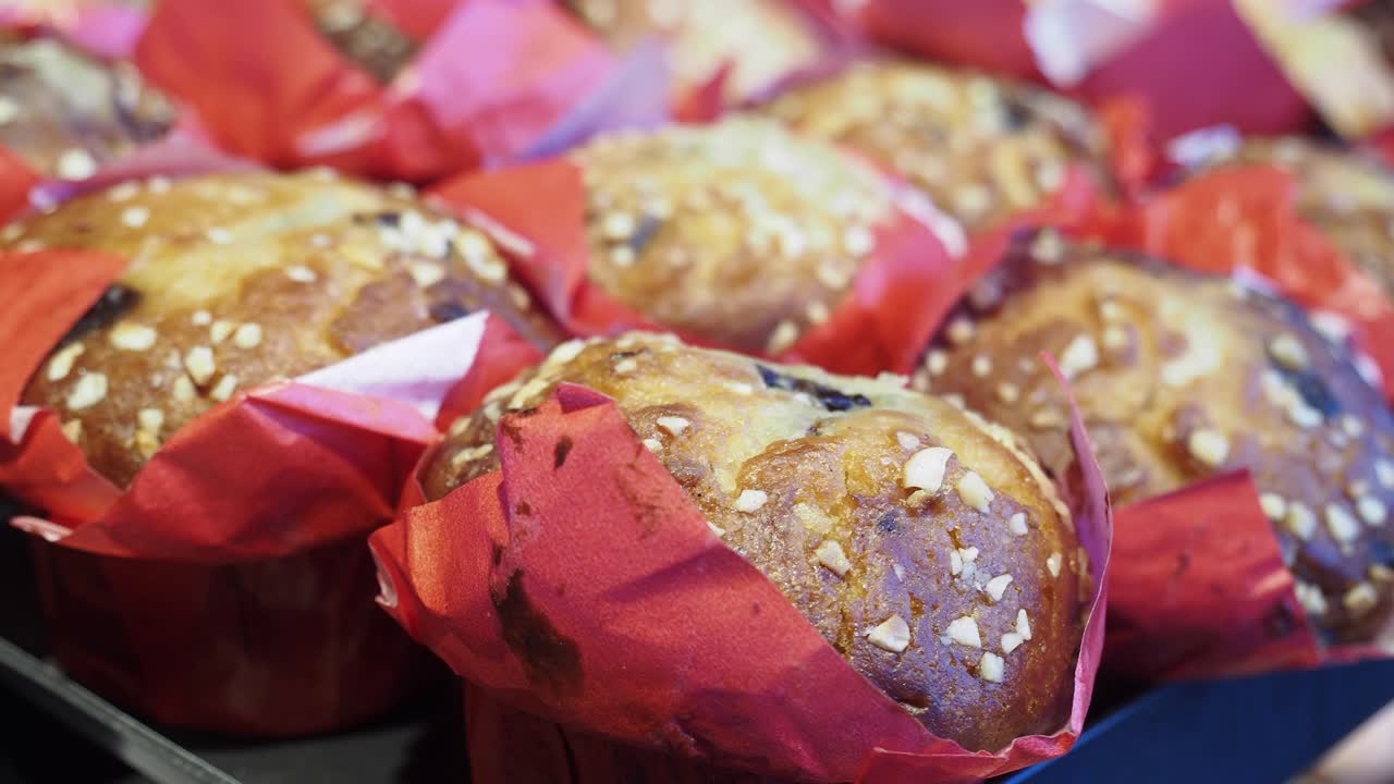 Close-up of delicious muffins with nuts in red wrappers