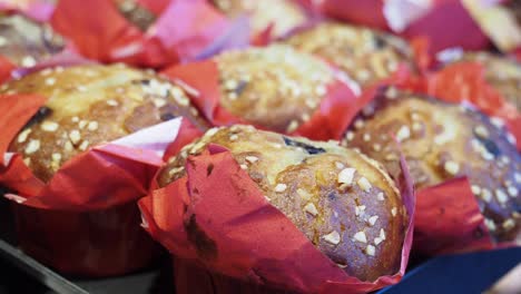 close-up of delicious muffins with nuts in red wrappers
