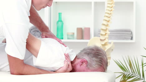 physiotherapist doing back massage to his patient