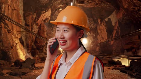 woman engineer talking on phone in a mine tunnel