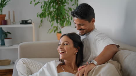 romantic couple enjoying movie at home vertical closeup. loving family resting