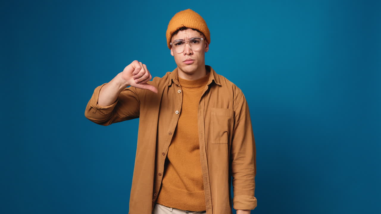 Man giving thumbs down with a sad expression