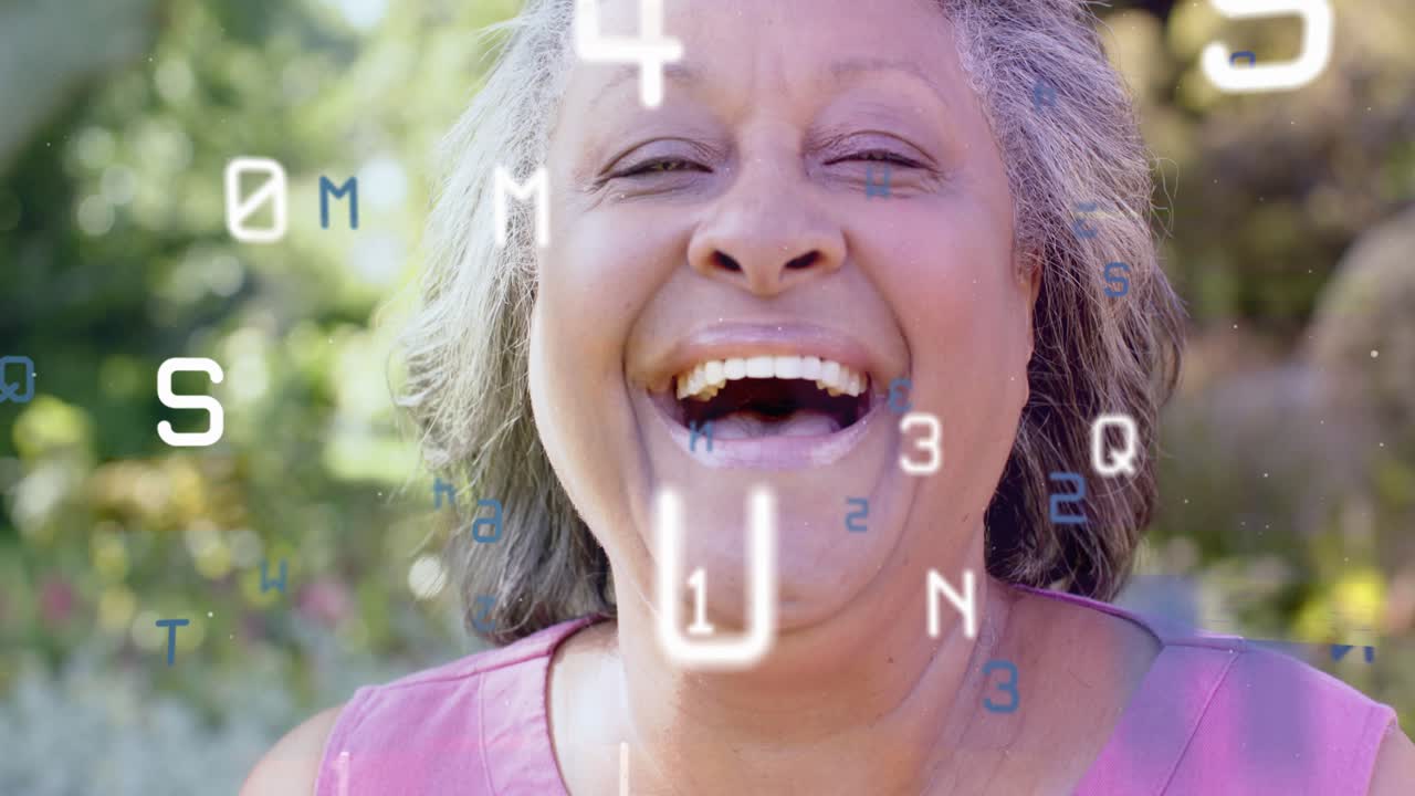 Senior woman holding gaze in garden letters floating past face causing smiling into laughing for IT
