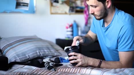 photographer cleaning his lenses at home, static shot