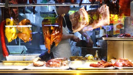 chefs preparing roast duck in a busy kitchen