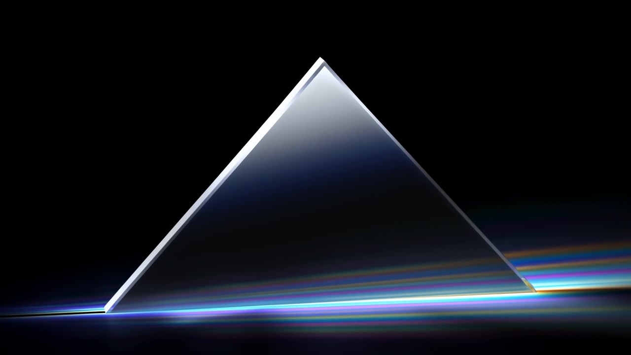 A clear glass prism stands slightly right of center on a black studio background, catching a bright beam near the bottom and dispersing it into vivid spectral