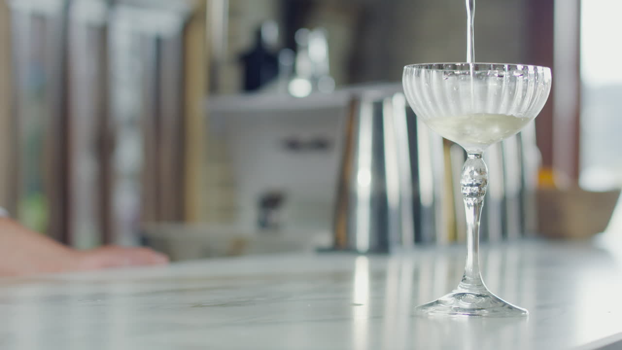 Close-up of a cocktail falling into a glass with an elegant and professional look