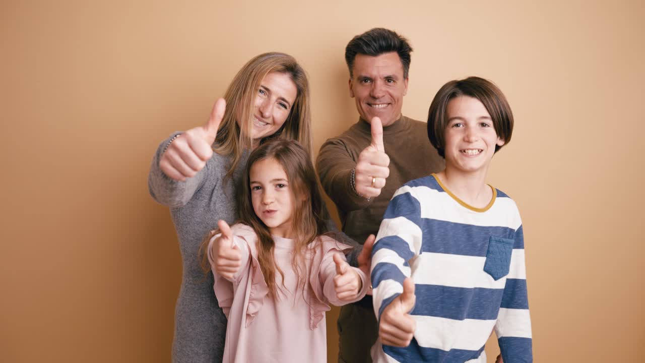 Happy Family Smiling and Giving Thumbs Up