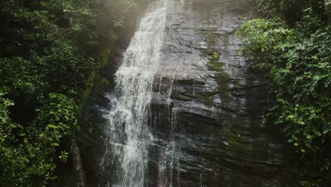 descending in front of waterfall with morning sun