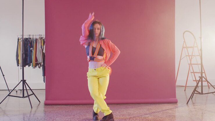 Portrait of happy caucasian female dancer dancing in dance studio, slow motion