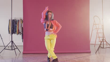 portrait of happy caucasian female dancer dancing in dance studio, slow motion