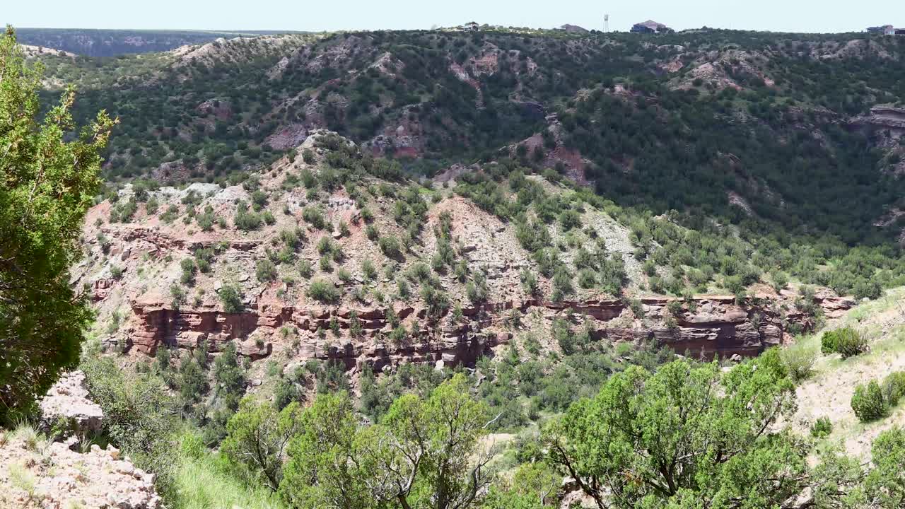 Scenic shot of Palo Duro Canyon State Park in Texas. A clouds shadow moves along the canyon