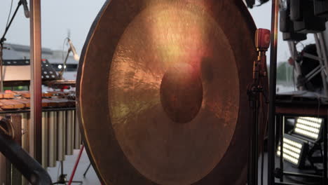 large metal gong at an outdoor concert