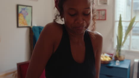 energetic african-american girl dancing at home
