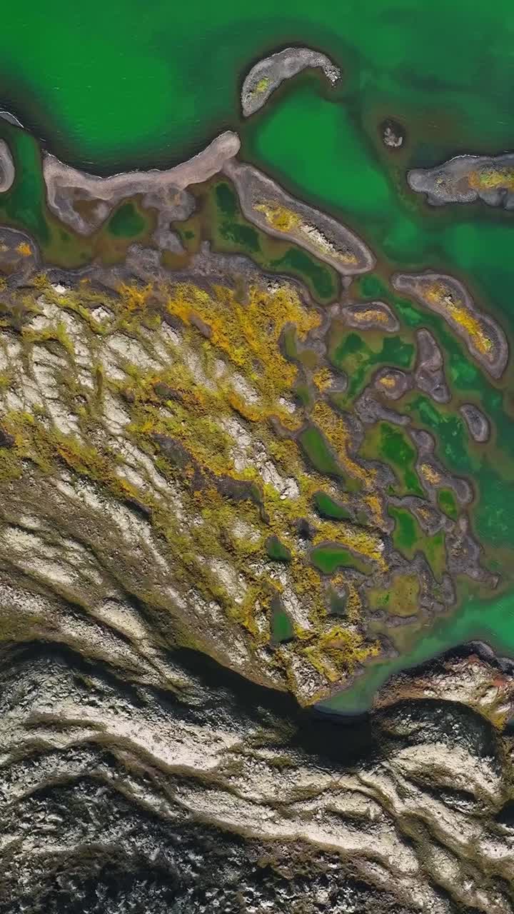 Colorful rock formations with moss in lake Iceland