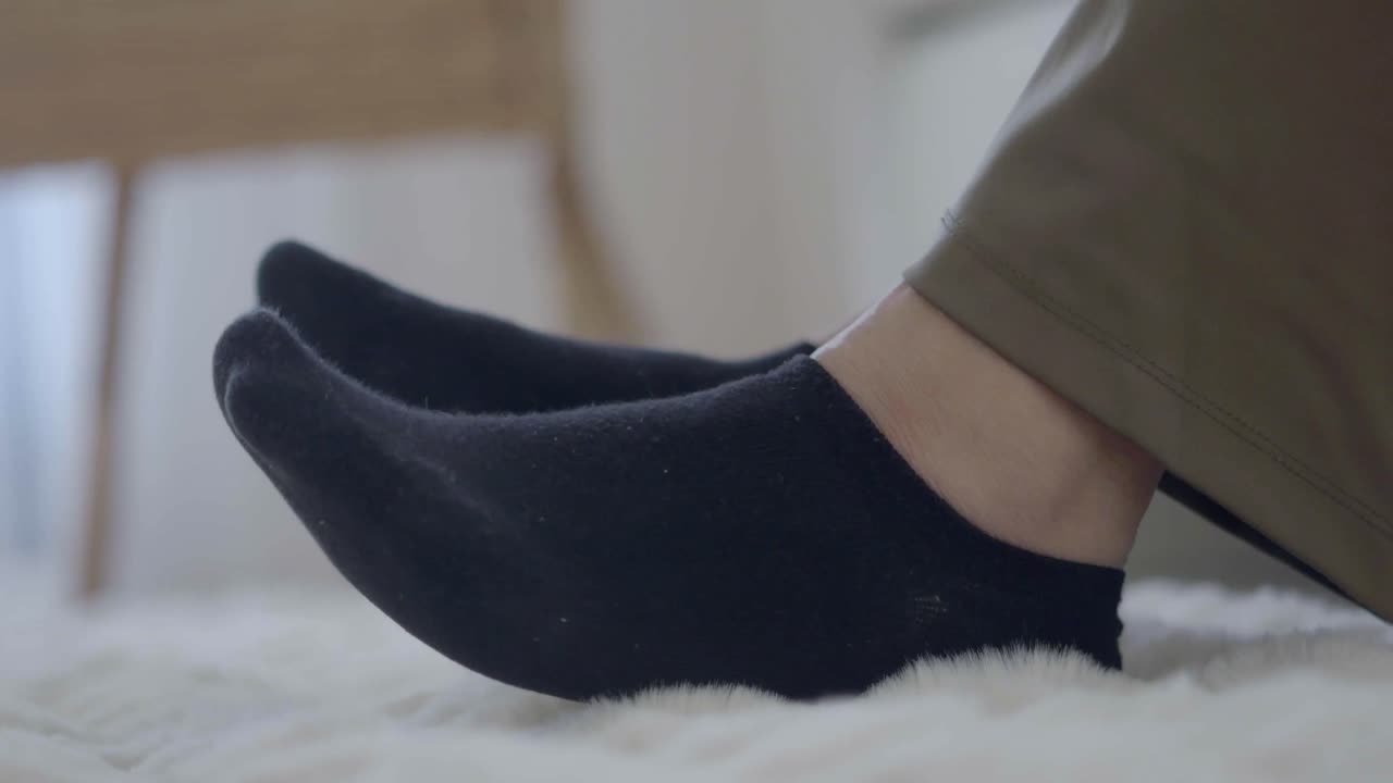 Black socks on fluffy carpet