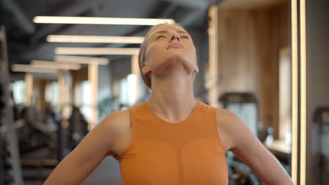 athlete woman doing exercises in sport club. sporty girl warming up at gym