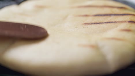 Pita-bread-on-griddle-being-flipped