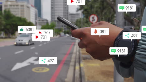 Animation-Von-Social-Media-Symbolen-Vor-Dem-Mittelteil-Eines-Mannes,-Der-Auf-Der-Straße-Sein-Smartphone-Benutzt