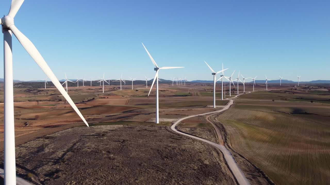 Windmills in field on sunny day