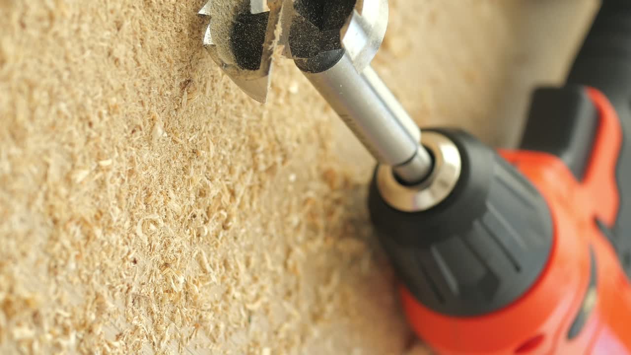 Close-up of a drill bit drilling into wood