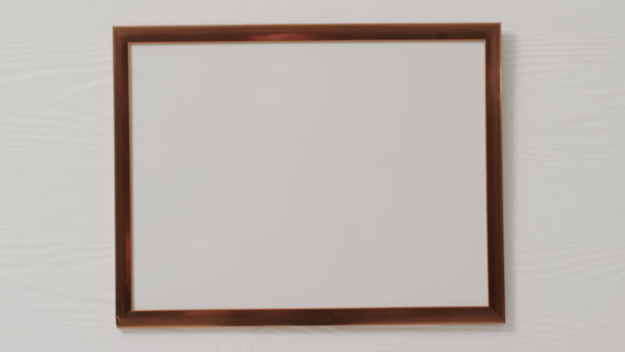 Wooden frame with copy space with white background and white wall