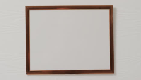 Wooden-frame-with-copy-space-with-white-background-and-white-wall