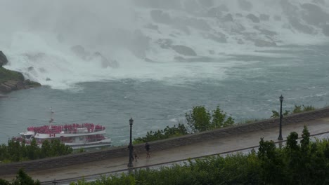 People-Running-Through-Rainy-Bad-Weather,-River-Ferry-Background,-High-Angle