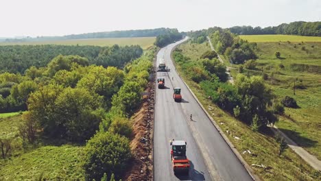 aerial view. laying a new asphalt on the road. road repair machine with heavy vibration roller compactor