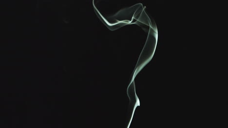 close up of white smoke from candle or incense drifting across frame against black background 1