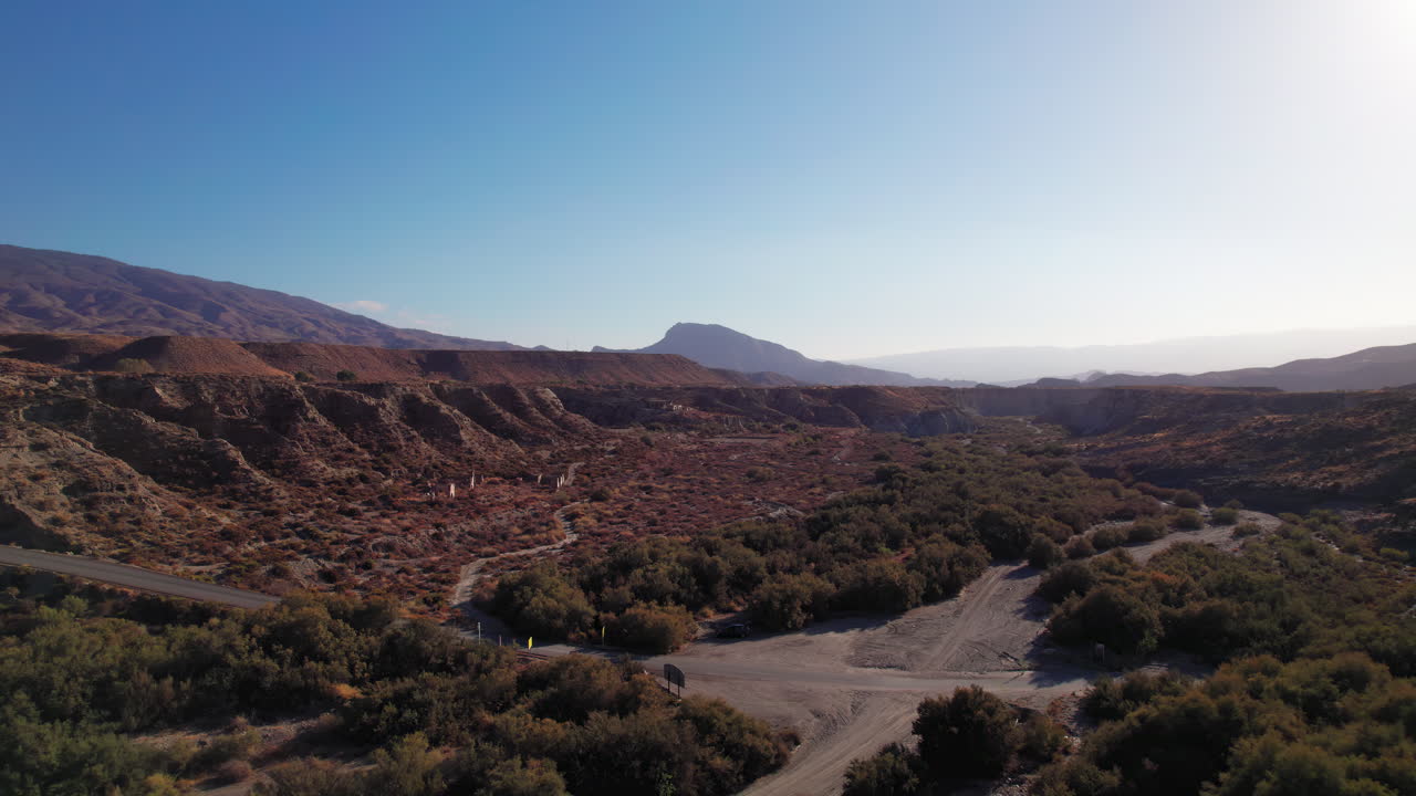 Aerial view of Tabernas desert in Almeria, Spain, moving backwards on late afternoon