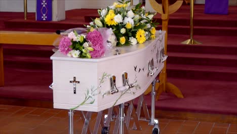 closeup shot of a funeral casket in a hearse or chapel or burial at cemetery