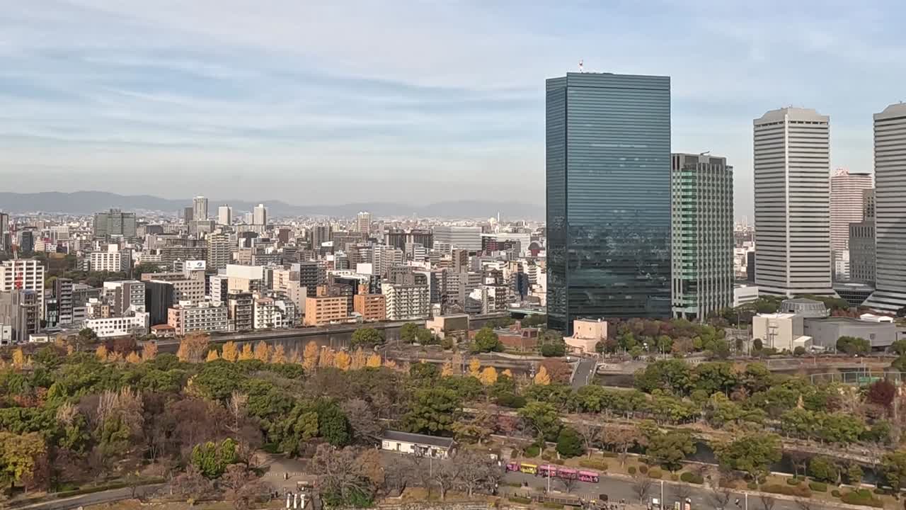 A dynamic view of skyscrapers overlooking a lush park, showcasing urban architecture and greenery.