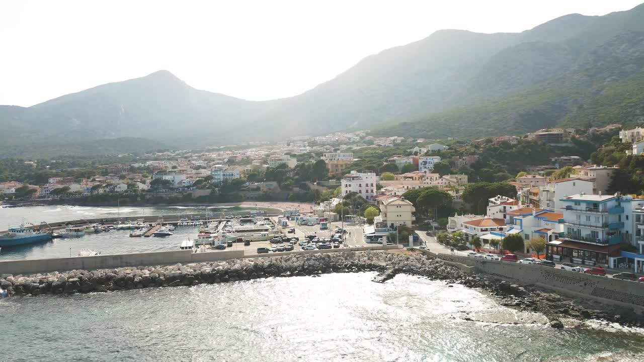 Panoramic View of a Scenic Coastal Town with a Harbor and Mountains