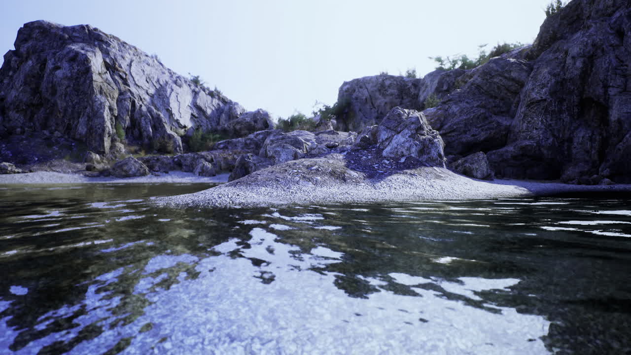 Serene water reflections in a rocky landscape under soft light